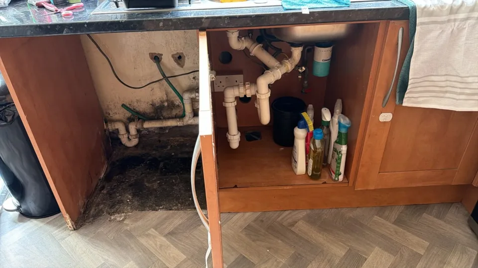 Original under-sink pipework and waste run at the Rayne kitchen job